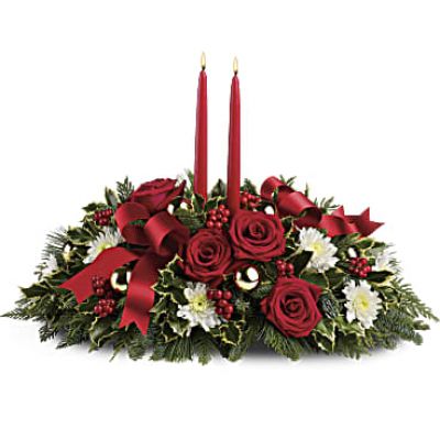 Make the season bright - and their table a delight - with the glowing tapers, radiant red roses and fresh Christmas greens of this stunning seasonal centerpiece.
This stunning centerpiece features red roses, white cushion spray chrysanthemums, variegated holly, noble fir, flat cedar, white pine, red berries, gold ornament balls, red ribbon, and red taper candles.