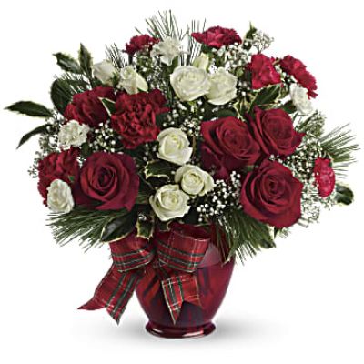 All dressed up in classic Christmas colors, this holiday floral arrangement is delivered in a delightful ruby red vase tied with plaid taffeta ribbon. White pine, holly branches and red and white blooms keep the feeling festive.

White roses and red and white carnations are mixed with delicate white million star gypsophila, holly branches and white pine.
Presented in a deep red vase with plaid taffeta ribbon bow.