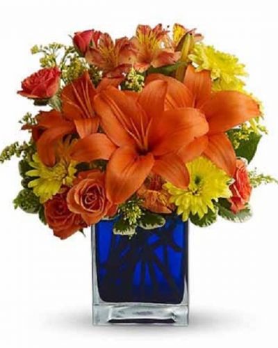 <div id="mark-3" class="m-pdp-tabs-marketing-description">Flower power rises several degrees in this brilliant array of hot summer flowers in a cool blue contemporary glass cube vase. Send this gift of indoor sunshine to someone close to you.</div>
<div id="desc-3">

The radiant bouquet includes orange Asiatic lilies, orange alstroemeria, yellow cushion spray chrysanthemums, solidago and orange spray roses accented with assorted greenery.

</div>