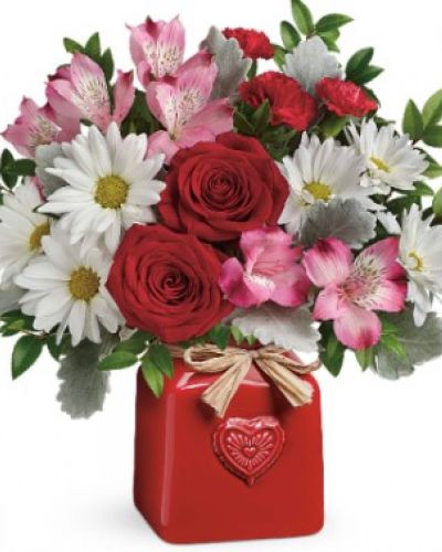 Sweet as can be! Surprise your sweetheart with this cute, country-style bouquet of red roses and white daisies, delivered in a cheerful ceramic crock with embossed heart and Italian raffia bow.
This bouquet includes red roses, pink alstroemeria, red miniature carnations, white daisy spray chrysanthemums, dusty miller and huckleberry. Delivered in a Country Sweetheart Crock.