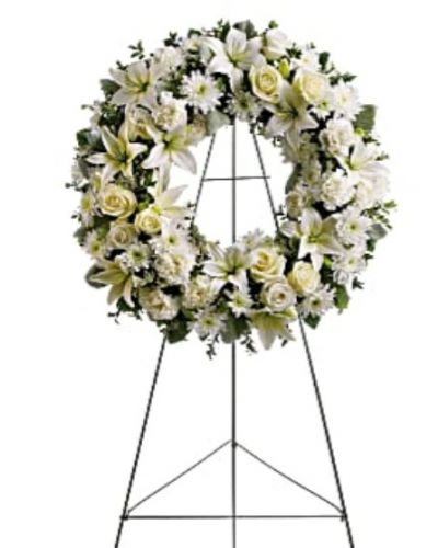 <div id="mark-1" class="m-pdp-tabs-marketing-description">Fragrant and ethereal white blossoms set among a ring of soothing greens form a classic wreath certain to evoke the pure heart and gentle spirit of a loved one – and offer consolation during a funeral or wake.</div>
<div id="desc-1">
<ul>
 	<li>Delivered on an easel, a standing wreath comprising fresh flowers such as white roses, asiatic lilies, carnations and chrysanthemums, as well as greens including salal, oregonia and dusty miller.</li>
</ul>
</div>