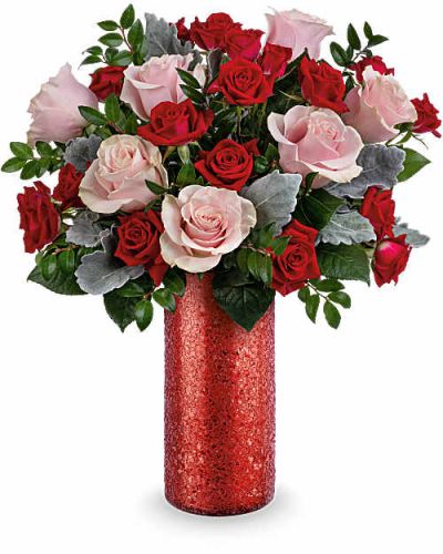 Make a stunning statement this Valentine's Day with Teleflora's Boldly Beautiful Bouquet-a modern mix of pink roses and red spray roses arranged in a dazzling red sparkle glass vase that radiates passion and confidence.