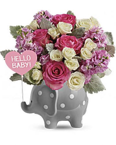 Celebrate a sweet girl's arrival with this precious ceramic elephant, bursting with pink blooms and darling polka dots!