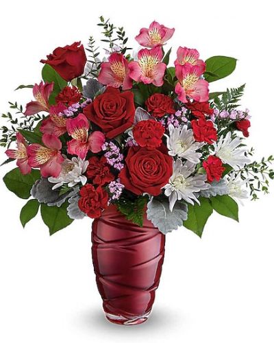 <div class="m-pdp-tabs-description">
<div id="mark-1" class="m-pdp-tabs-marketing-description">Honor the beauty of true love with this vibrant Valentine's Day bouquet of red roses, beautifully arranged in pearlescent glass vase with an eye-catching swirling design.</div>
</div>
<p id="arrngDescp">This stunning Valentine's Day bouquet features vibrant red roses, pink alstroemeria, and miniature red carnations, complemented by white cushion spray chrysanthemums and pink sinuata statice. Beautifully arranged in a Loving Swirls vase.</p>