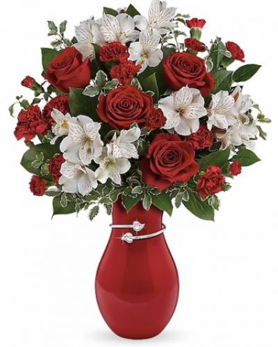 <div class="m-pdp-tabs-description">
<div id="mark-1" class="m-pdp-tabs-marketing-description">Two hearts that beat as one! A romantic tribute to your love, this Valentine's Day surprise is one that she'll never forget. Passionate red roses and delicate white alstroemeria look oh-so-lovely in this stunning, hand-glazed vase with a shimmering metallic hearts band.</div>
</div>
<p id="arrngDescp">This heartfelt bouquet includes red roses, white alstroemeria, red miniature carnations, lemon leaf and pitta negra. Delivered in a Pair Of Hearts vase.</p>