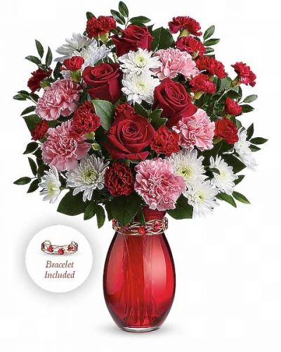Embrace this Valentine's Day with beauty and romance! Nothing is sweeter than this charming 3-in-1 gift that includes a pink and red bouquet of roses, carnations and chrysanthemums hand-delivered in a stunning hand-blown red glass vase wrapped with a gorgeous adjustable bracelet made of golden wire and shimmering red hearts. It's sure to earn you an embrace or two!