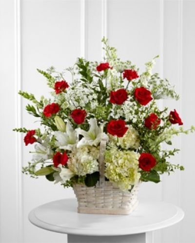 The FTD® In Loving Memory™ Arrangement pays tribute to a life well-lived with every beautiful bloom. Red roses and carnations pop amongst this incredible arrangement of white hydrangea, Oriental lilies, snapdragons, larkspur, Queen Anne's Lace and assorted lush greens, lovingly arranged in a large whitewash rectangular basket to create an impressive display of caring kindness.