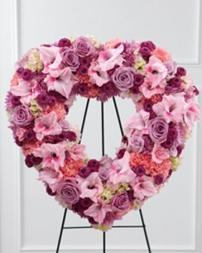 The FTD® Eternal Rest™ Standing Heart bursts with love and sweet comfort to honor the deceased at their final farewell service. Lavender roses, pink carnations, purple button poms, lavender chrysanthemums, pink gladiolus and pink hydrangea are beautifully arranged in a the shape of a heart and displayed on a wire easel to create a stunning display of warm affection that will last in the hearts of friends and family for years to come.