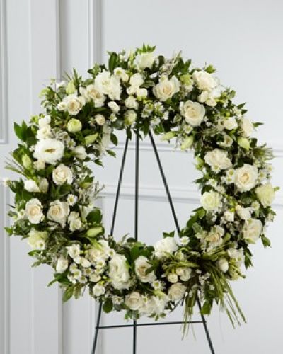 The FTD® Splendor™ Wreath is a symbol of lasting love and kinship, whether for the deceased or in comfort of those suffering from a loss. Elegant white freesia, double lisianthus, spray roses, monte casino asters and limonium are accented with a variety of lush greens and green raffia ribbon, perfectly arranged in the form of a wreath, to create a beautiful way to display your sincere sentiments.