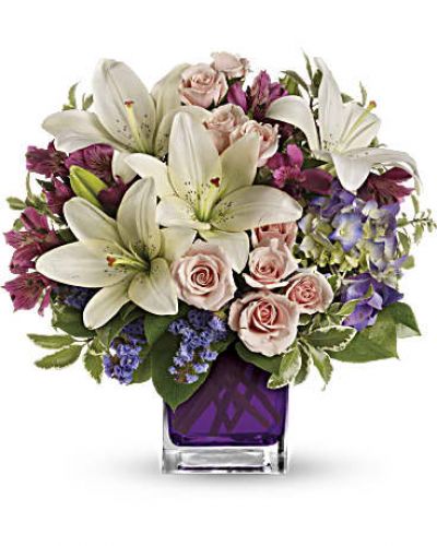 Va-va-bloom! This grand array of purple hydrangea, light pink spray roses and white asiatic lilies is presented in our violet cube.