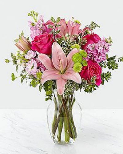 The Pink Posh Bouquet is chic and pink to help you celebrate life's most treasured moments in style! Hot pink roses are bright and beautiful arranged amongst pink Asiatic Lilies, pink gilly flower, green button poms, bupleurum and lush greens to create that perfect gift of flowers. Presented in a clear glass vase, this blushing fresh flower arrangement is ready to send your sweetest wishes in honor of a birthday, an anniversary, or as a way to express your thanks and gratitude.

STANDARD bouquet is approx. 16H x 13W.
DELUXE bouquet is approx. 17H x 14W.
PREMIUM bouquet is approx. 18H x 15W.