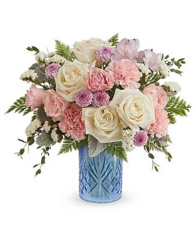 The Blue Belle Bouquet is a sweet Mother's Day flower arrangement of soft pink, white, and lavender blooms, beautifully presented in the Blue Belle Vase keepsake-perfect for celebrating Mom with fresh spring charm.
The Blue Belle Bouquet features white roses, pink spray roses, lavender alstroemeria, pink carnations, lavender button spray chrysanthemums, and white sinuata statice, accented with dusty miller, parvifolia eucalyptus, and Cleopatra leatherleaf fern, in the Blue Belle Vase.