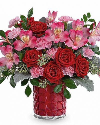 <div id="mark-3" class="m-pdp-tabs-marketing-description">Adorned with a charming heart pattern and gleaming with a pearlescent finish, this delightful glass vase adds an extra touch of magic to their Valentine's Day when filled with a stunning red and pink bouquet.</div>
&nbsp;
<div id="desc-3">This Valentine's Day arrangement features red spray roses, pink alstroemeria, and miniature light pink carnations, complemented by dusty miller, seeded eucalyptus, and huckleberry. This vibrant red and pink bouquet is delivered in Teleflora's Enchanted Hearts Vase.</div>